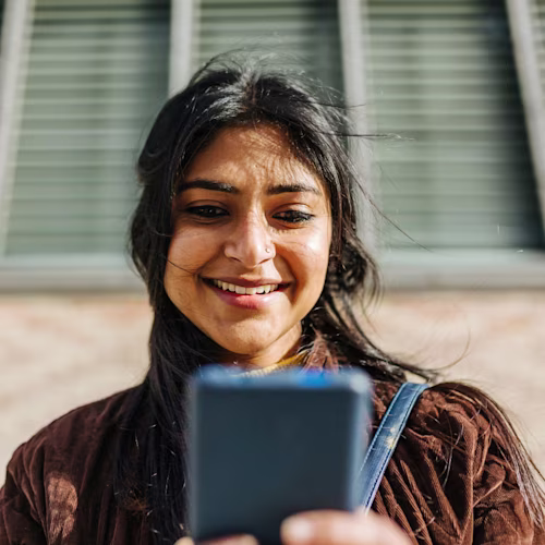 Woman wearing a corduroy jacket using a mobile phone
